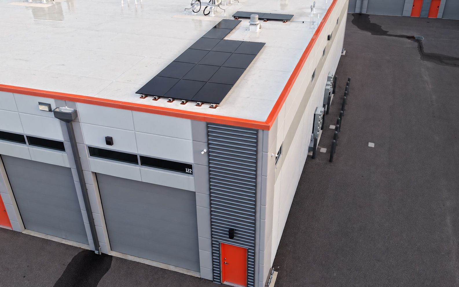 Paddock1 commercial building with rooftop solar panels and orange architectural trim